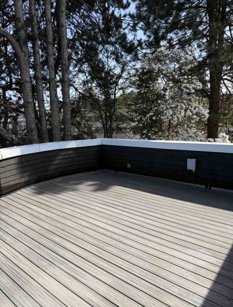 Surface cleaner washing the tiles of a rooftop terrace with an ocean view in White Rock